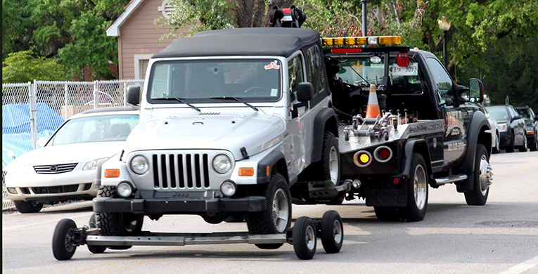 The vehicle of a student involved in a self-inflicted gunshot wound was towed away from the scene on Championship Boulevard near the district May 2.