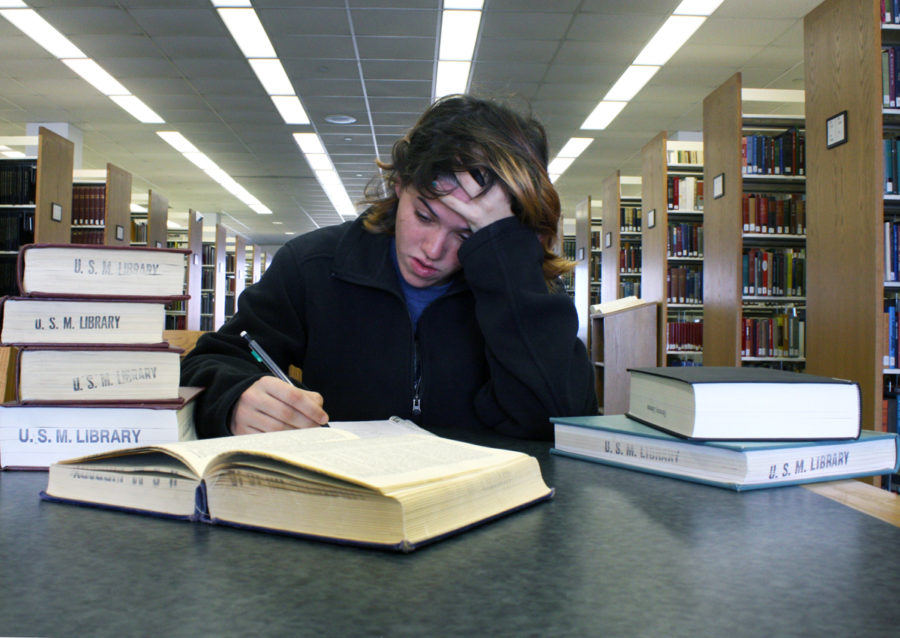 Kenadie Kostmayer studying in the library.