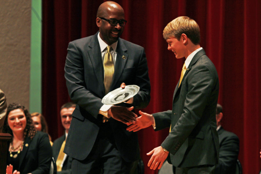 Rodney Bennett presents Brandon Baker with a plate commemorating his acceptance into the Student Hall of Fame Thursday afternoon in Bennett Auditorium. 

Zachary Odom / Printz