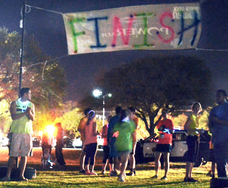 Onlookers cheer racers as they finish the Glow Run Thursday night.  Participating runners dressed in neon clothing and glowing accessories to take part in the 5K that began on Pride Field and winded its way all around Southern Miss campus. 

Michael Kavitz/Printz