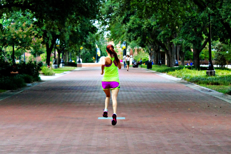 Chelsey Thomas, a junior fashion merchandising major, frequently runs on campus to maintain her healhty lifestyle. Running every day is an important aspect to getting into shape and keeping up ones daily physical activity. | Photo by Meredith Bennett
