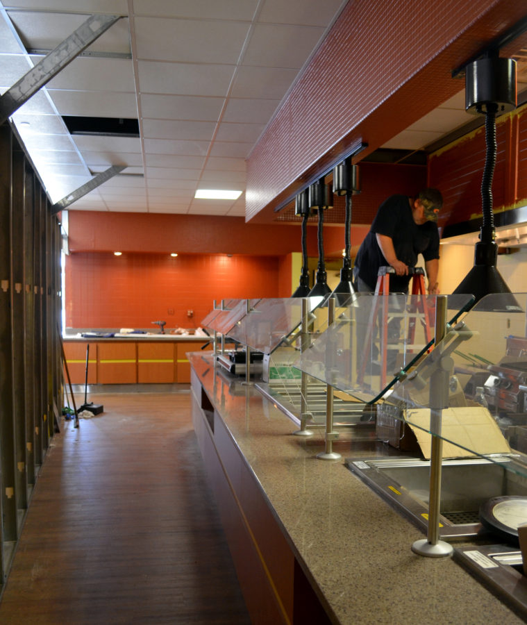 Behind the red wooden wall that separates the Hillcrest dining area from construction, the cafeterias buffet recieves a facelift. A fresh paint job and new counters are among the residence halls renovations.  