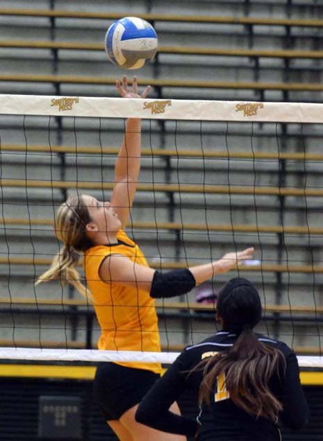 USM senior Kristen Fleming tips the ball over the net during the eagles scrimmage match in the Reed Green Coliseum in August. - Michael Kavitz