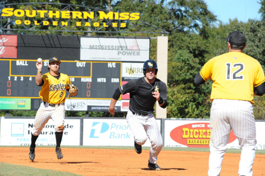 Senior Austin Roussel finds himself caught between first and second base as junior Nick Dawson and senior Matt Durst attempt to tag him out during the USM Baseball Breast Cancer Awaremness Fall World Series 
this weekend.  - Michael Kravitz/Printz