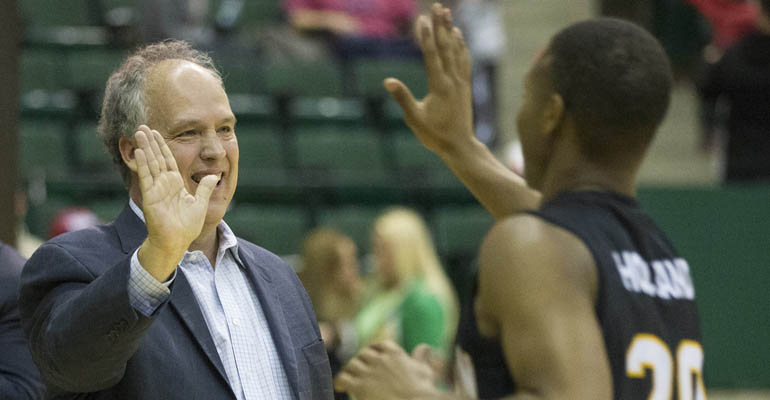 Jan 24, 2015; Denton, TX, USA; Southern Miss Golden Eagles head coach Doc Sadler (L) congratulates guard Kevin Holland (20) after the game against the North Texas Mean Green at UNT Coliseum. The Golden Eagles won in overtime 75-71. Mandatory Credit: Tim Heitman-USA TODAY Sports
