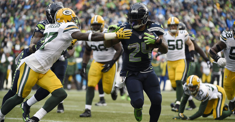 January 18, 2015; Seattle, WA, USA; Seattle Seahawks running back Marshawn Lynch (24) runs the ball against Green Bay Packers cornerback Sam Shields (37) during the second half in the NFC Championship game at CenturyLink Field. Mandatory Credit: Kyle Terada-USA TODAY Sports