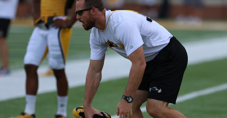 Zac Woodfin stretching out a player before practice on August 20, 2015