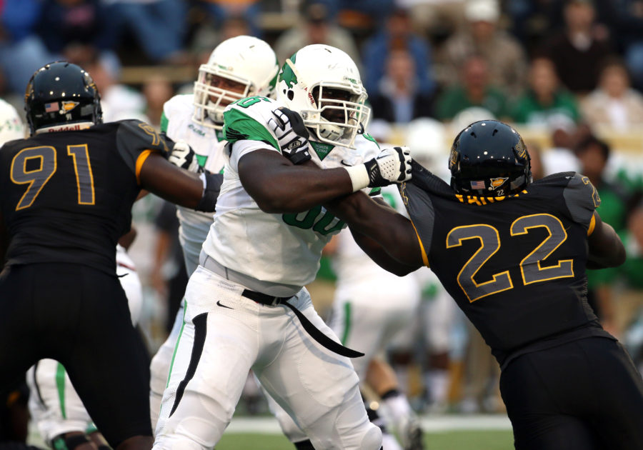 Southern Miss linebacker Darian Yancey pushes a North Texas player away Saturday night in Hattiesburg, Mississippi on October 3, 2015. (Student Printz/ Fadi Shahin)