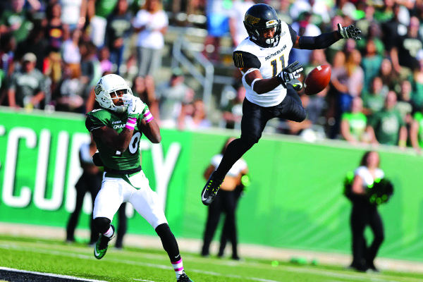 Golden Eagles defensive back Kalan Reed (11) leaps in the air for an interception intended for Charlotte 49ers wide receiver Austin Duke (10) Jim Dedmon-USA TODAY Sports