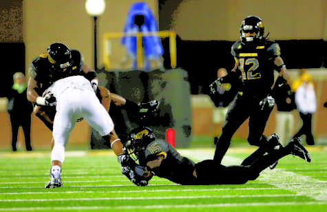 Devonta Foster(15) and Korey Robinson(18) tackle a Old Dominion player during the fourth quarter of play at the last home game for Southern Miss on Nov 21. The Golden Eagles won against the Monarchs 56-31.
