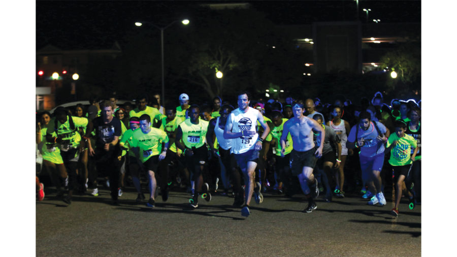 Participants of the 5K glow run Running at the beginning of the race on Tuesday, April 19.