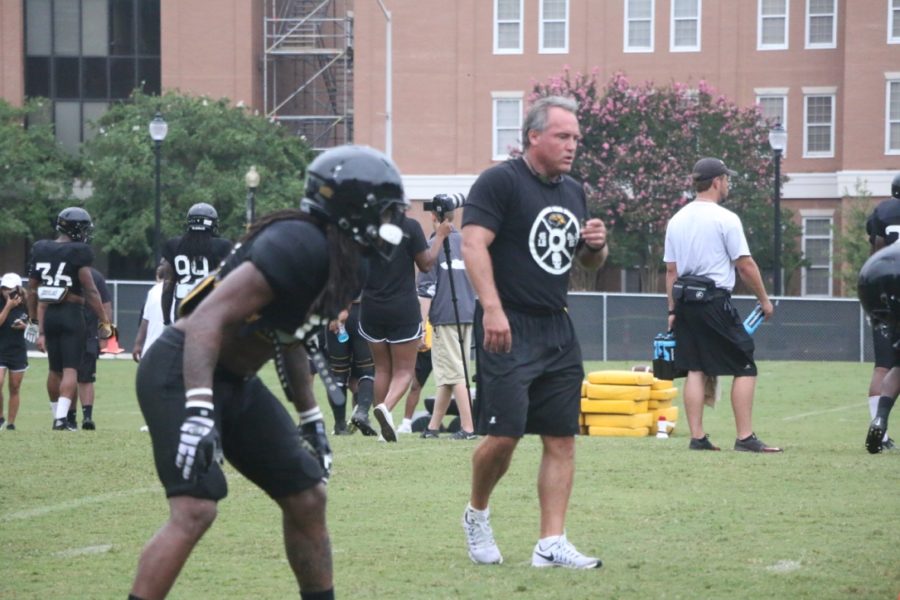 Coach Jay Hopson (right) coaches safety DNerius Antoine (left) during a practice drill on Aug. 20. 