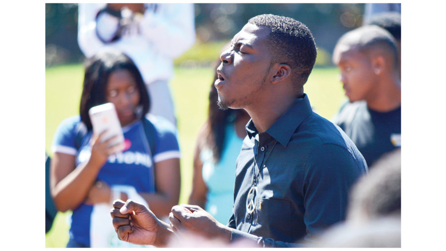 A USM student leads prayer before the protest at Shoemaker Square on Oct. 3. Cam Bonelli/Printz