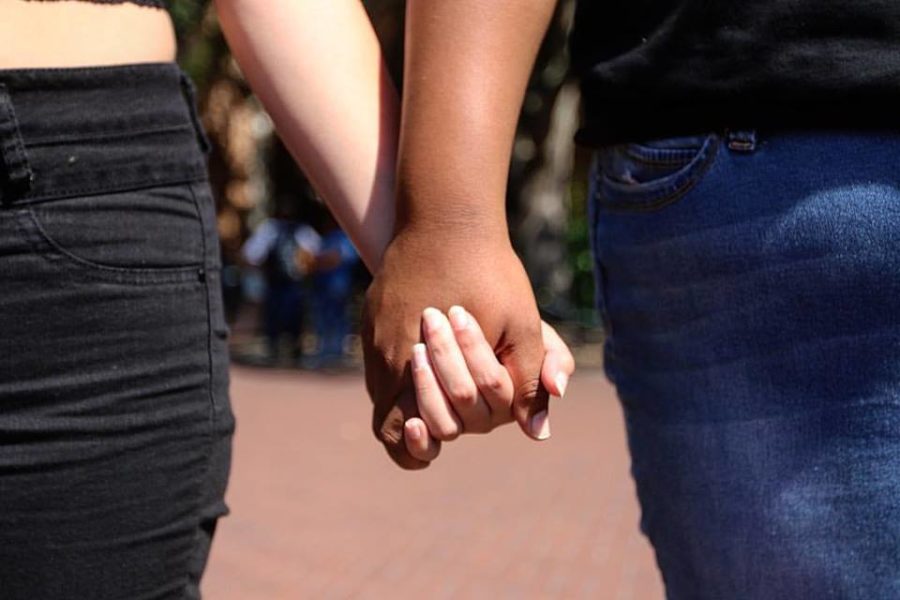 Lindsey Hargrave (left) and Chelsea Nelson (right) hold hands at a #blacklivesmatter protest at the University of Southern Mississippi in Hattiesburg on Oct. 3, 2016. The protest formed today in response of two African American girls who sat down during the national anthem at the Rice-USM football game this past Saturday. The two girls were yelled at and had food and drinks thrown at them for their protest. (Hunt Mercier/ The Student Printz)