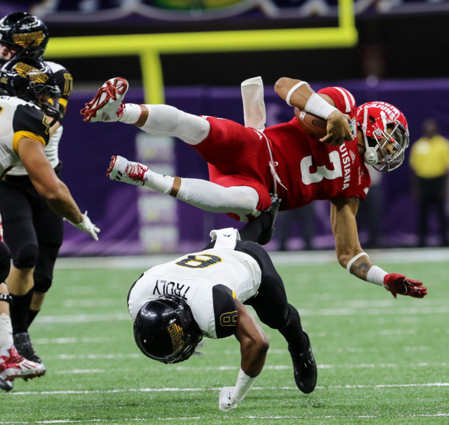Southern Miss defensive back Deshadrick Truly (8) dives to tackle Ragin Cajun quarterback Jordan Davis (3) at the New Orleans Bowl on Dec. 17, 2016 in New Orleans, Louisiana.