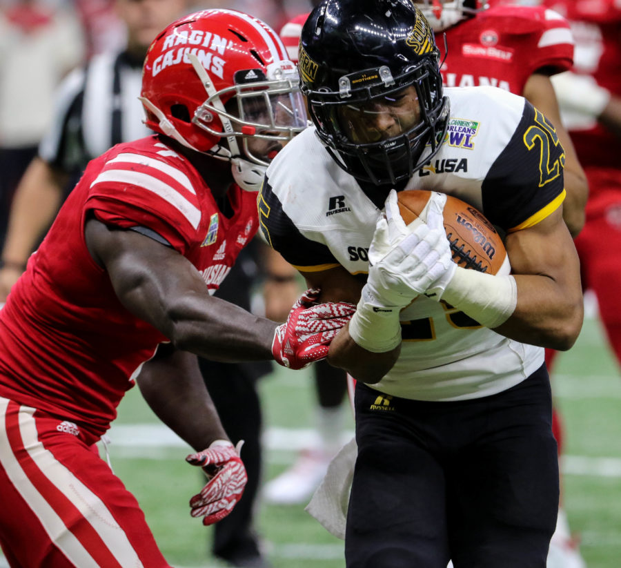Southern Miss running back Ito Smith breaks free from a tackle to score a touch down against the Ragin Cajuns at the New Orleans Bowl on Dec. 17, 2016 in New Orleans, Louisiana.