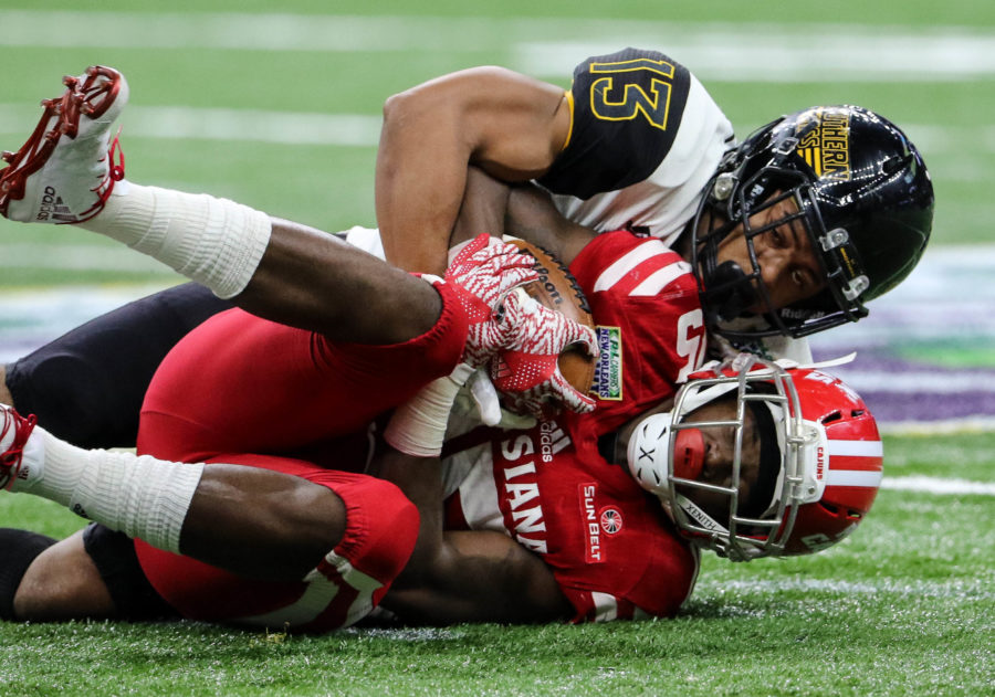 Southern Miss defensive back Picasso Nelson Jr. (13) tackles Ragin Cajun running back Elijah McGuire (15) at the New Orleans Bowl on Dec. 17, 2016 in New Orleans, Louisiana.