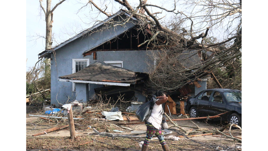 A Pine Belt resident walks with what is left of her belongings following the storm on Jan. 21 on Edwards St. in Hattiesburg.