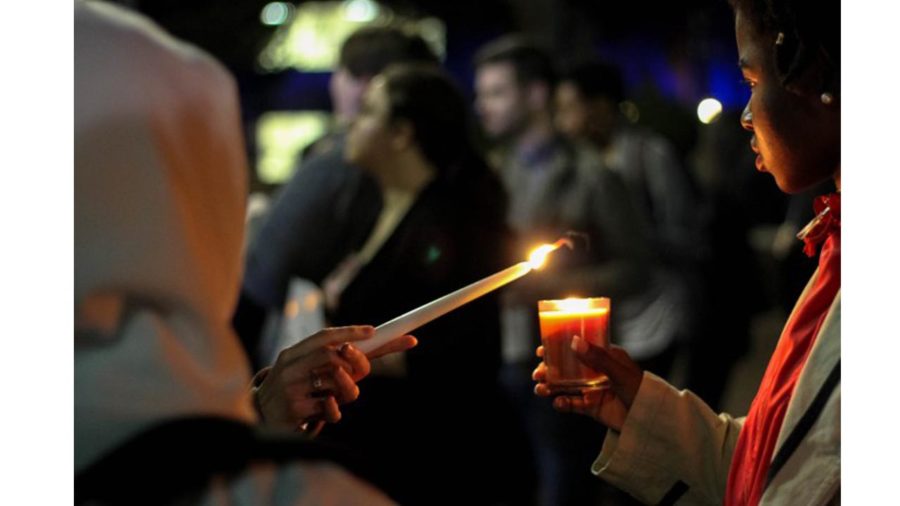Two USM students light candles before the vigil to honor refugees, immigrants and Muslims on Monday, Jan. 30, 2016 (Carly Snyder|Printz).  