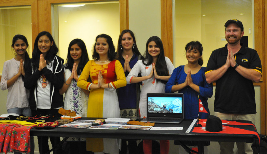 Nepali students pose in “Namaste” which means “hello” in Nepali during the International fair on Feb. 23.