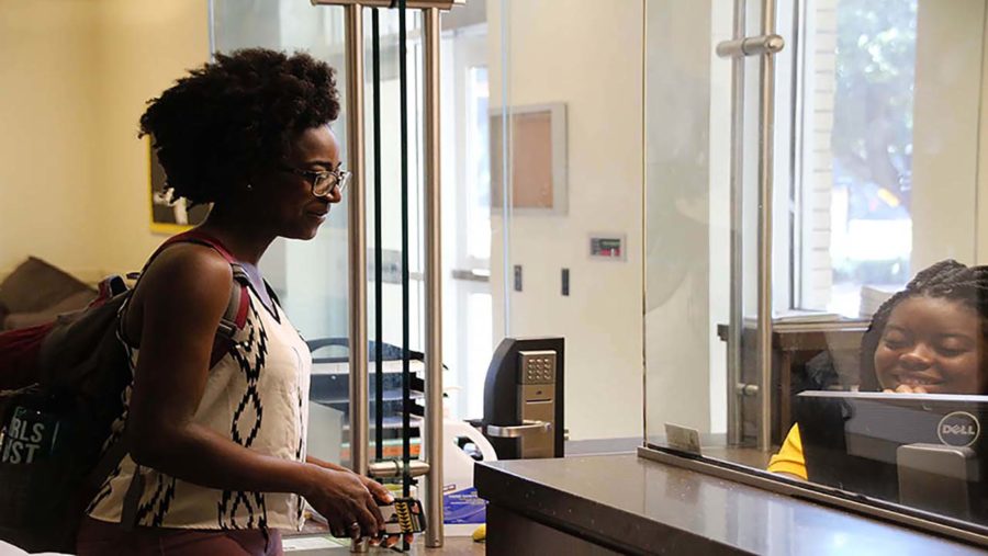 Student being checked in at the front desk of the resident hall.
Photo: Gabrielle Williams