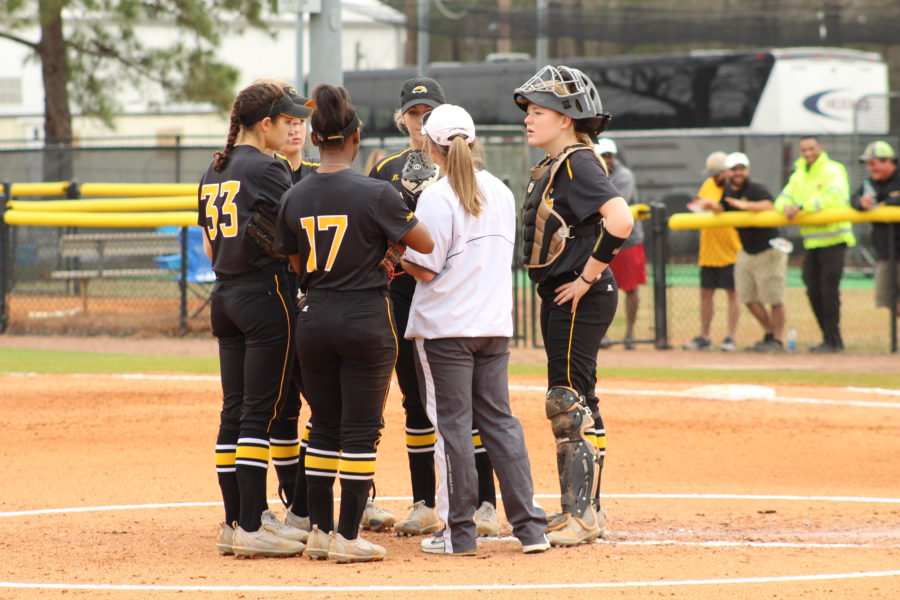 Head coach Wendy Hogue huddles with her team at home on Feb 18.
