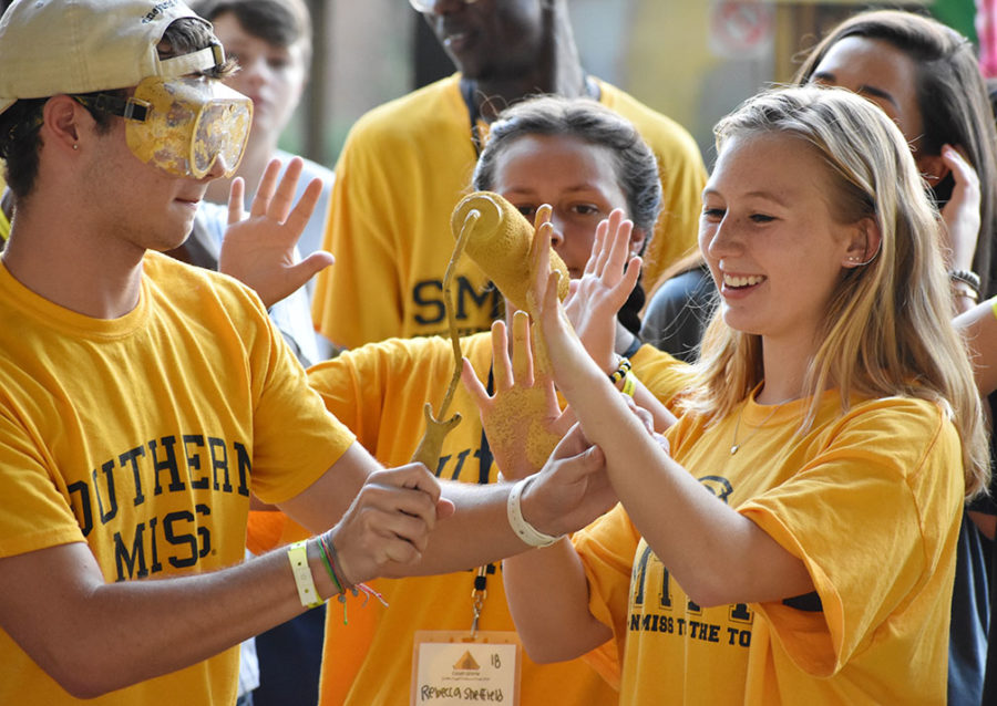 Southern Miss freshmen participate in the tradional painting of the Eagle Walk.
