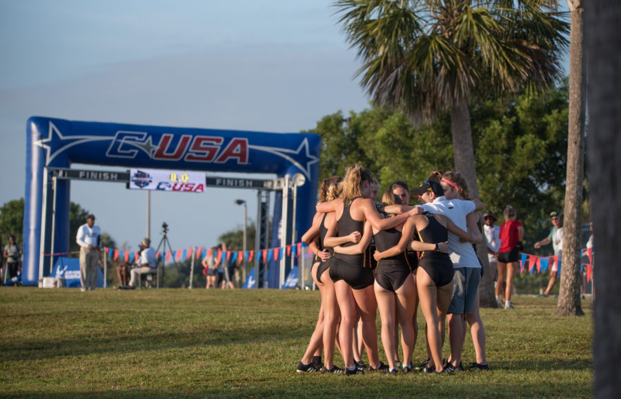 Coach Aaron Kindt huddles the team up before the start of race. 

Photo by: Michael Sandoz