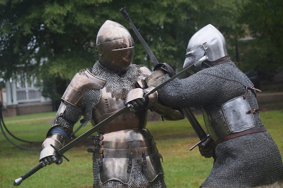 Students observe medieval combat reenactment