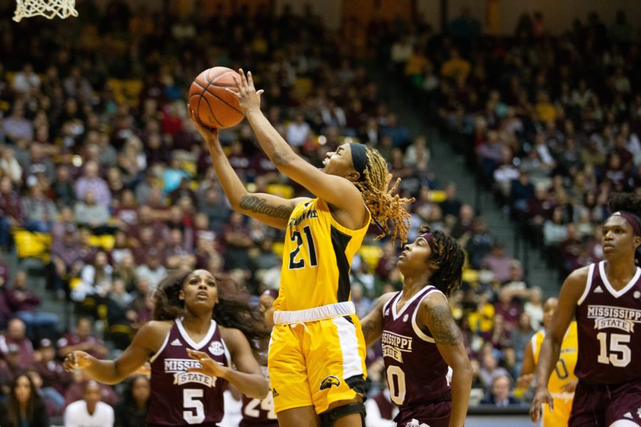Freshman+point+guard+Daishai+Almond+goes+for+lay+up.%0APhoto+by%3A+Brad+Crowe+