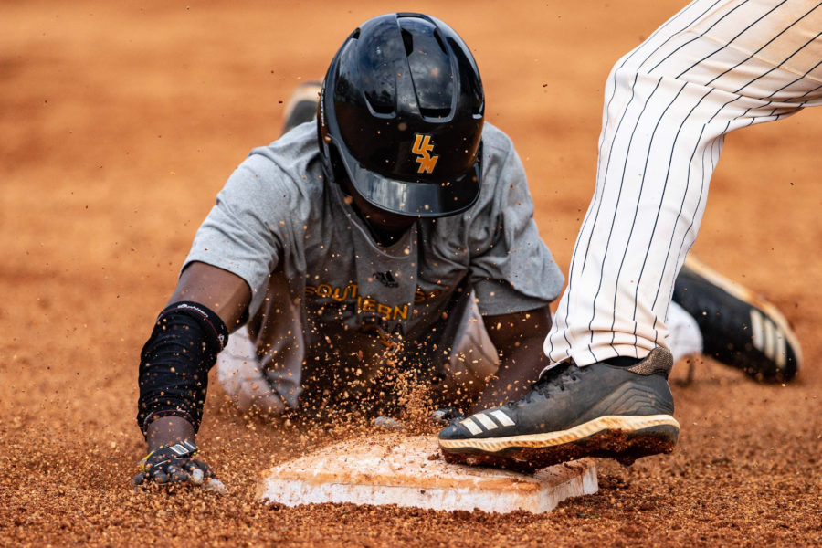 Fred Franklin slides into third base. Photo by: Brad Crowe