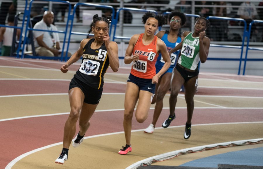 Rian Robinson leads her heat of the Womens 400 meter Dash