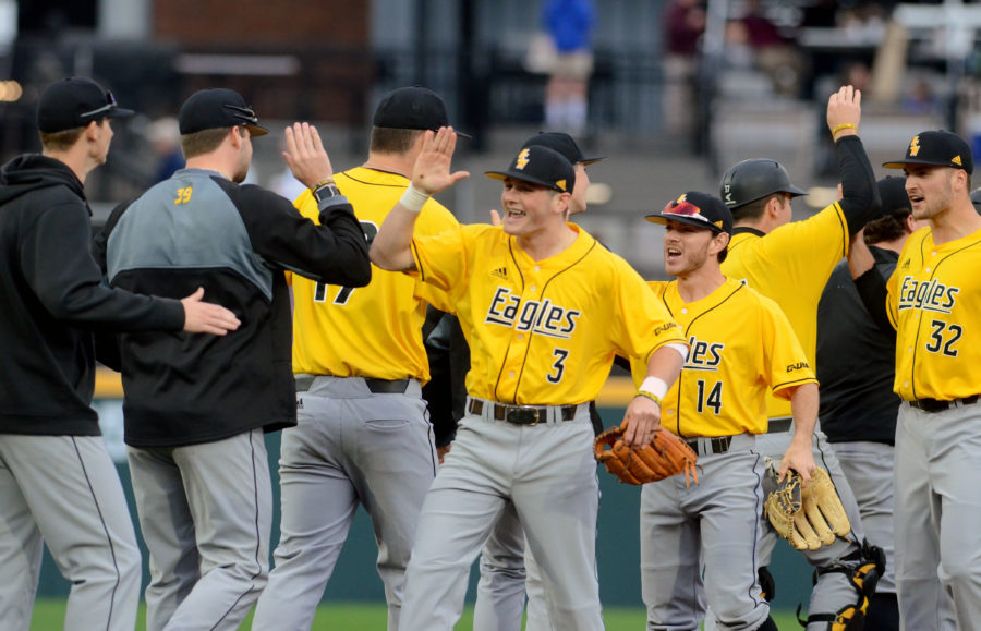The+Golden+Eagles+celebrate+a+win+over+Mississippi+State+after+extra+innings.+