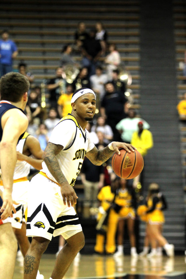 Tyree Griffin dribbles ball down court.

Photo by: Bethany Morris