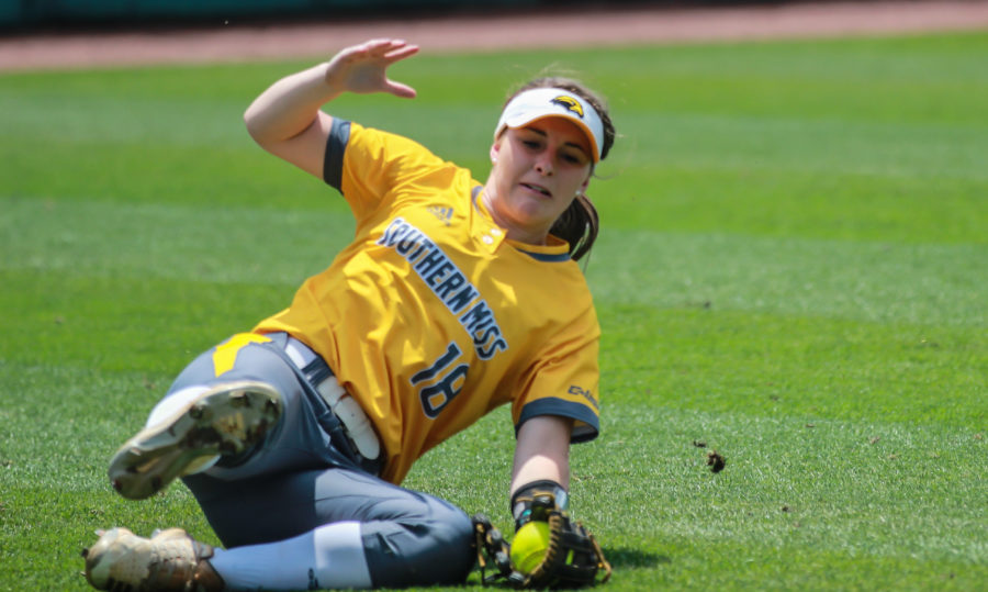 Freshman Madison Rayner makes a diving catch in left field. 

Photo by: Makayla Puckett 