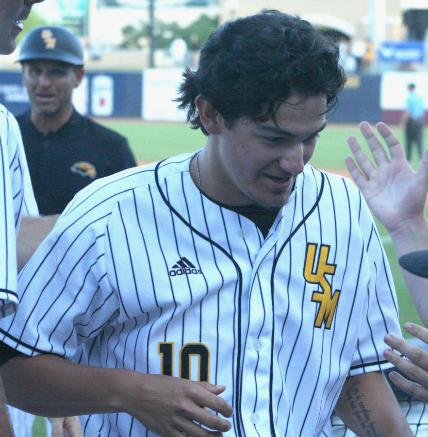 Storme Cooper walks in the dugout after scoring the tying run. Photo by: Andrew Abadie