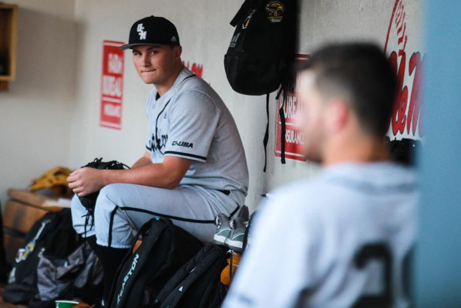 Drew Boyd sits in the dugout between innings. 
Photo by: Makayla Puckett 