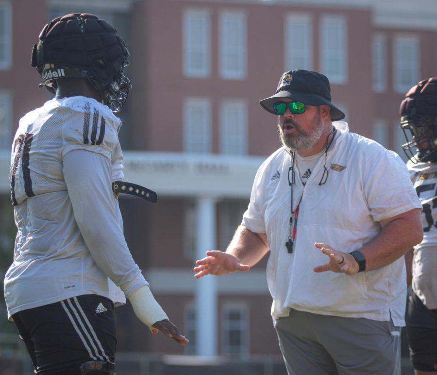 Sam Gregg works with offensive lineman Paul Gainer, Jr. during fall camp.