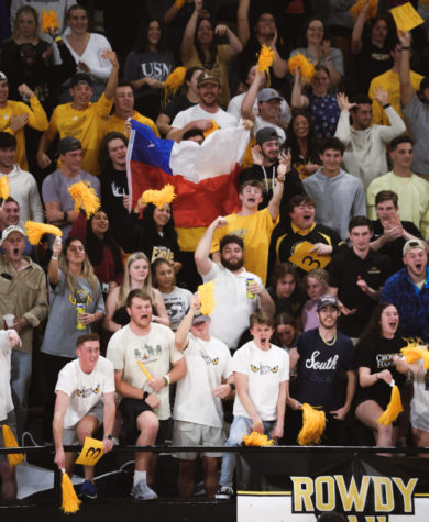 Southern Miss students hold up a Chilean flag in support of the new international players
