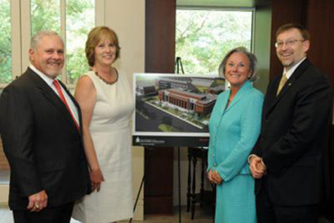 July, 20011: Southern Miss alumnus Chuck Scianna, far left, and his wife, Rita, admire an artist's rendering of the College of Business building that will bear his name alongside President Martha Saunders, second from right, and Dr. Lance Nail, dean of the College of Business.