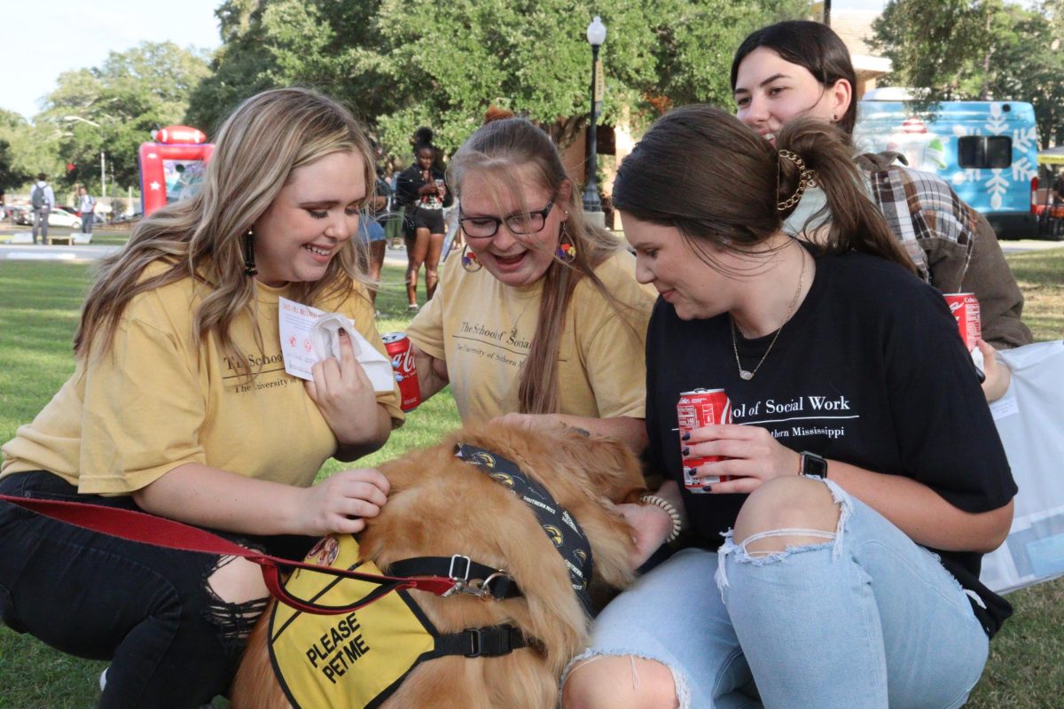 People at the Fall Wellness Festival gathered to enjoy food, fun, and furry friends like Cash Money the Therapy Dog.
