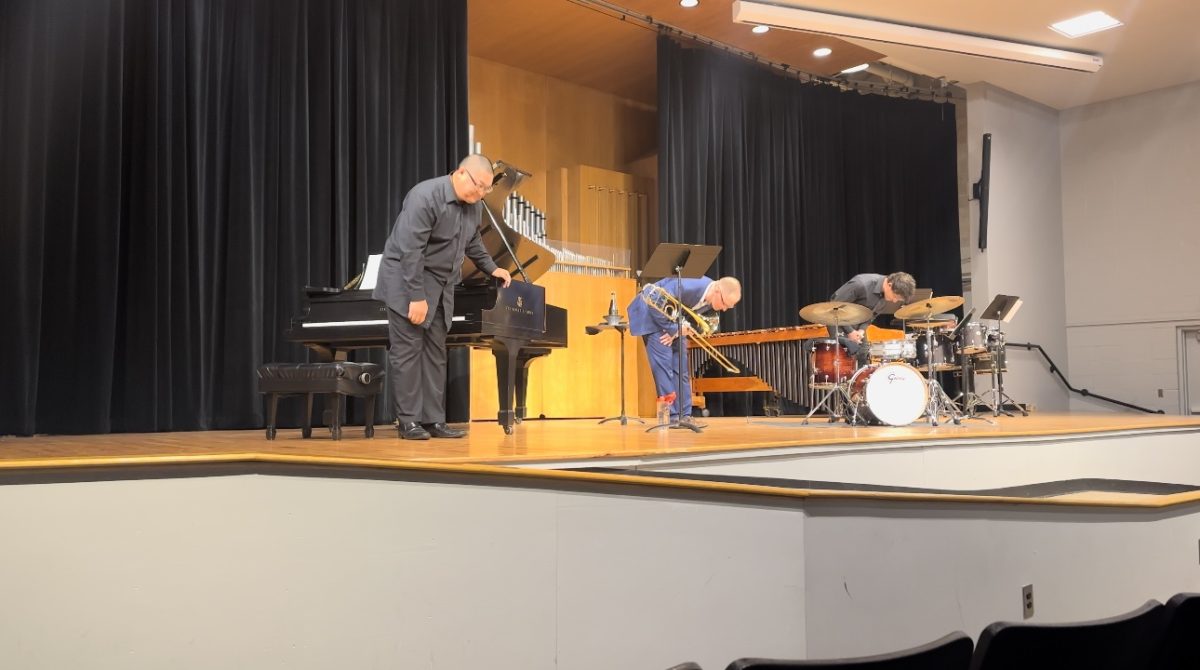 Caleb Owenby, Nathan Sanders, and Zhaolei Xie bowing after their performance.