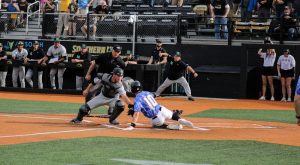 Lawson Odom (10) slides into home plate in the bottom of the 13th inning. Hes called out, but he scores on a catchers obstruction to walk off the game. - Dima Mixon