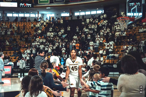 USM's Melyia Grayson greets kids before a game.