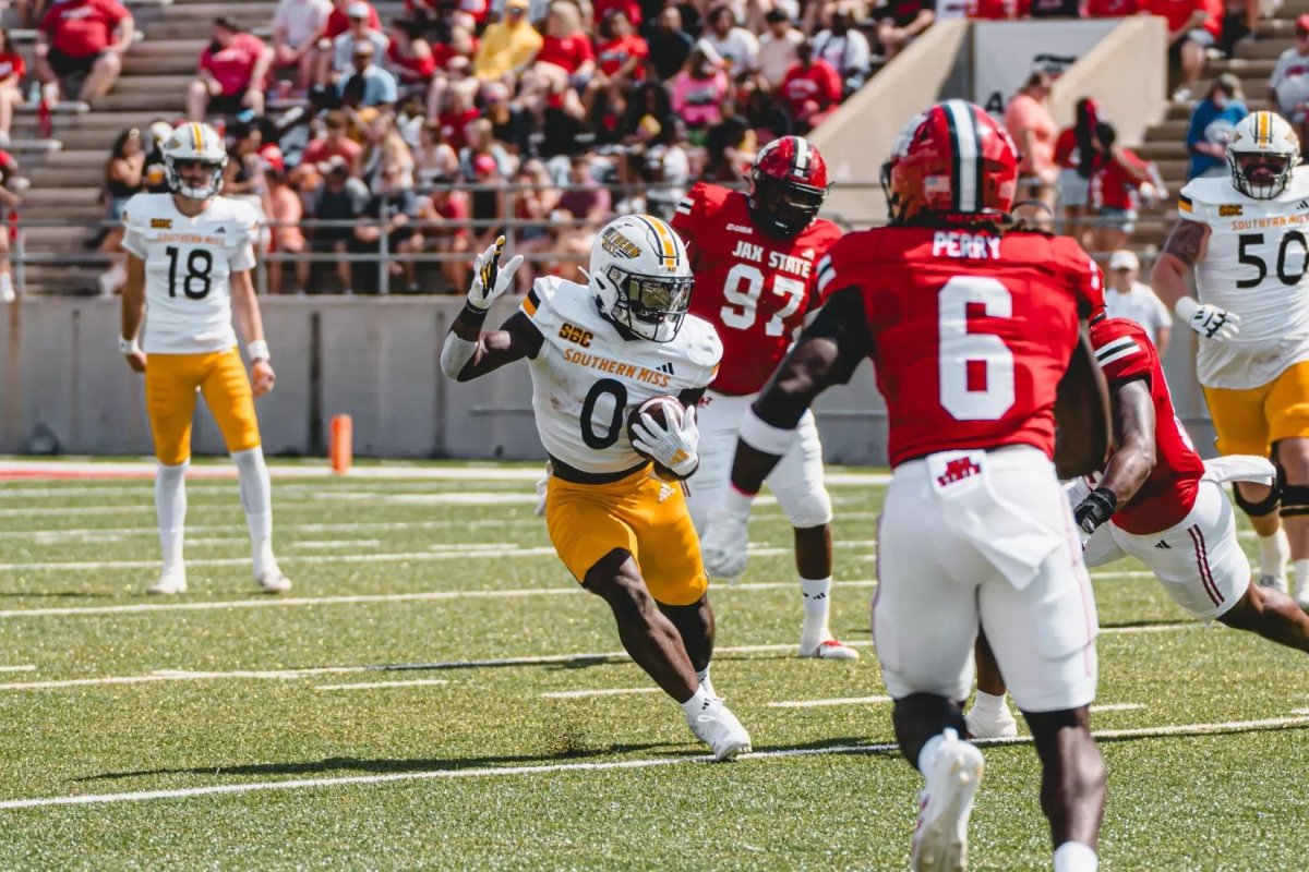 USM's Rodrigues Clark rushes between defenders in a recent game against Jacksonville State.