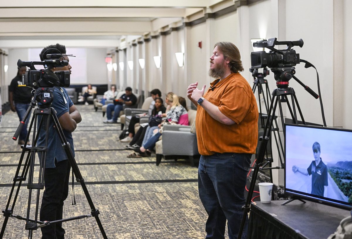 Jayden Cutler, a student journalist from Northwest Rankin High School, interviews Dr. RJ Morgan, Mississippi Scholastic Press Association (MSPA) Director. 