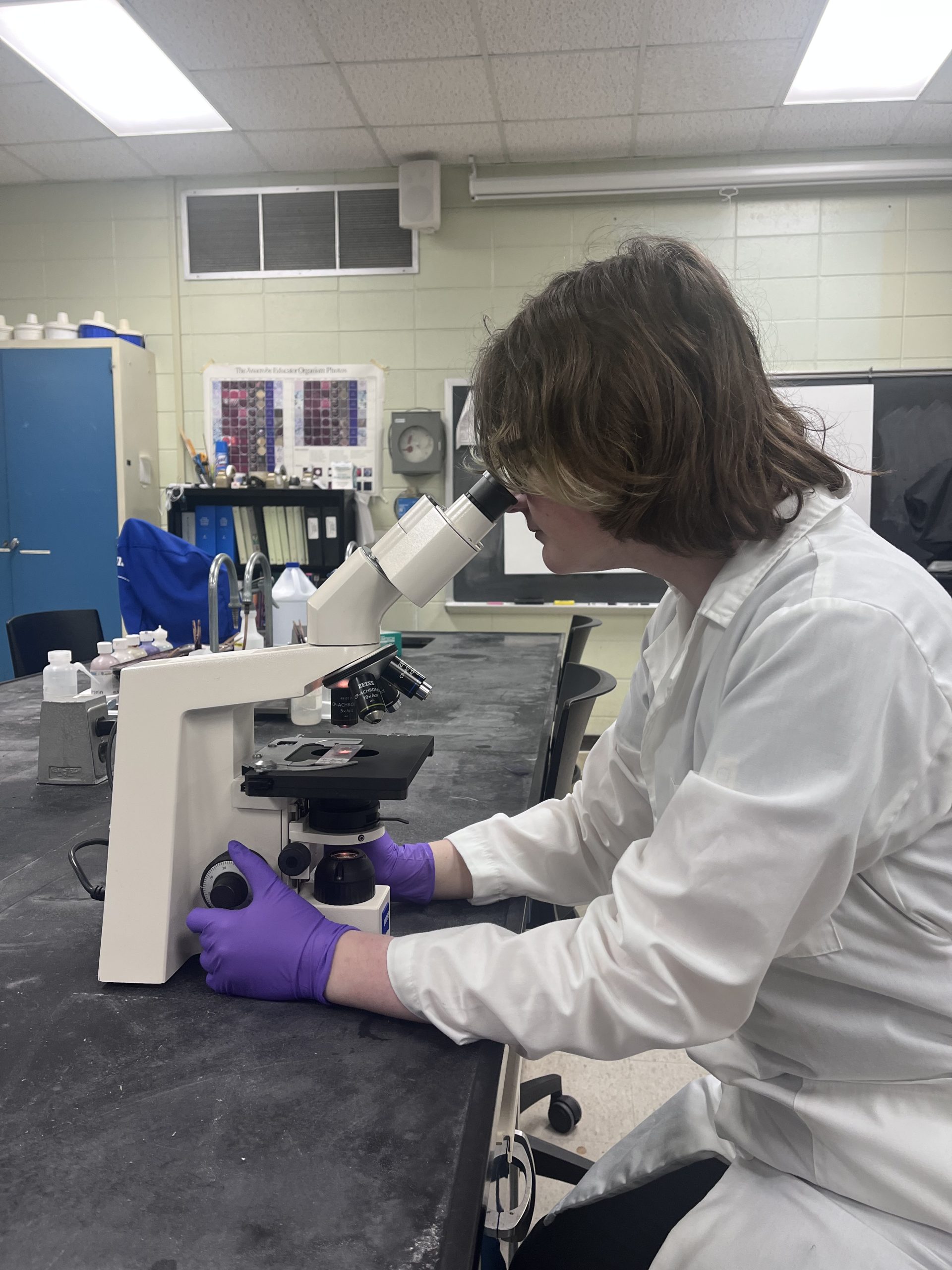 Madison Waters, a Medical Laboratory Science student at USM, studies samples through a microscope.