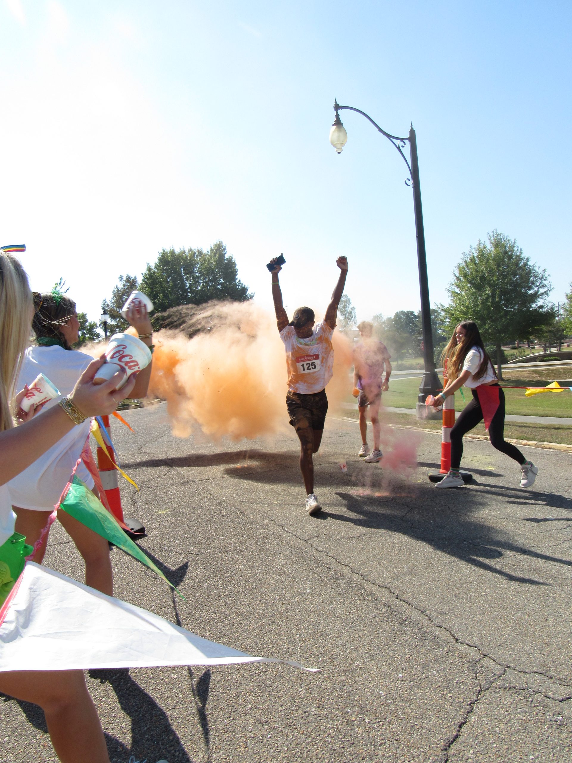 A runner crosses the finish line of Kappa Delta's 1-mile color run. 