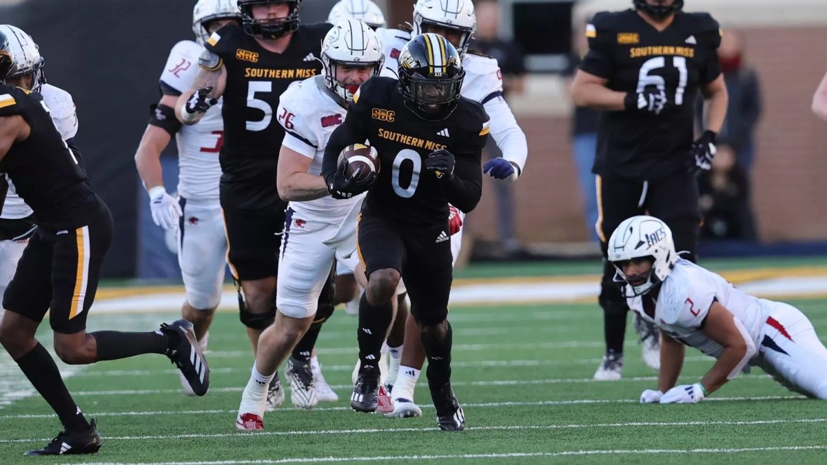 USM running back Dreke Clark run between defenders.