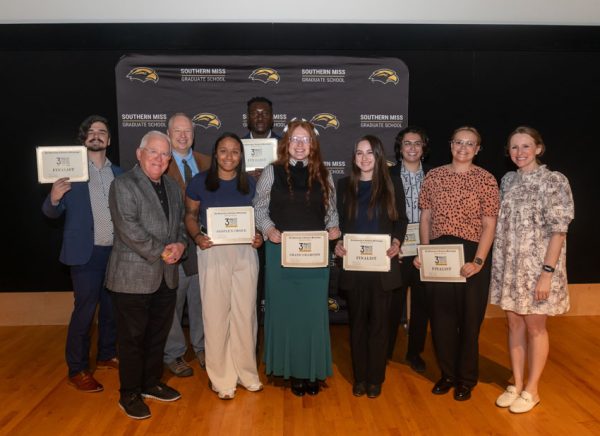 Winners of the "Three-Minute Thesis" Competition with Dr. Joe Paul.
Back Row left to right: Michael Oeth, Matt Martin, and Godspower Okeke. Front Row left to right: Dr. Joe Paul, Madeline Klubertanz, and Alyssa Sha.